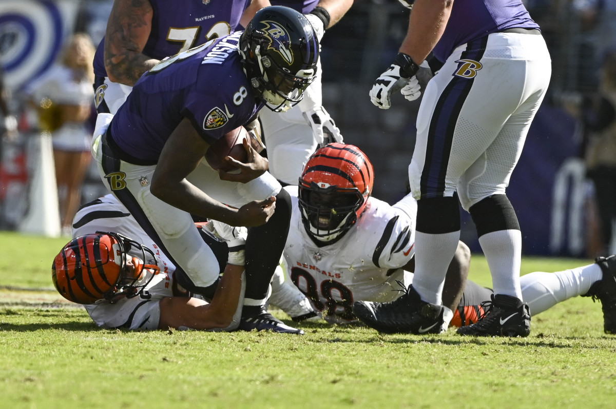 Oct 24, 2021; Baltimore, Maryland, USA; Cincinnati Bengals defensive end Sam Hubbard (94) and defensive tackle D.J. Reader (98) sack Baltimore Ravens quarterback Lamar Jackson (8) during the first half at M&T Bank Stadium. Mandatory Credit: Tommy Gilligan-USA TODAY Sports
